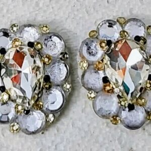 Elegant stud earrings featuring a central teardrop-shaped rhinestone surrounded by shimmering silver beads and tiny gold accents.